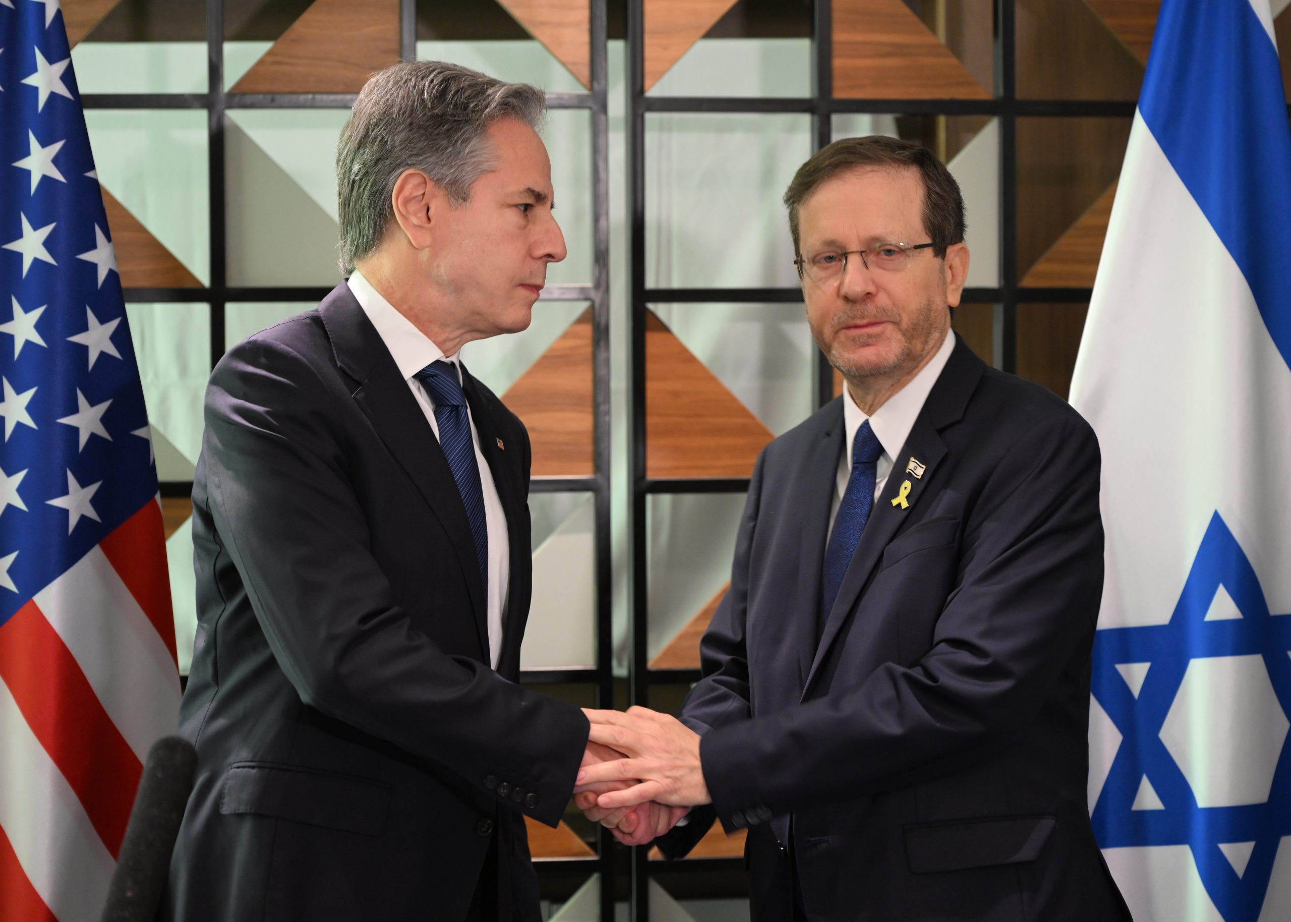 U.S. and Israeli officials with both nations' flags